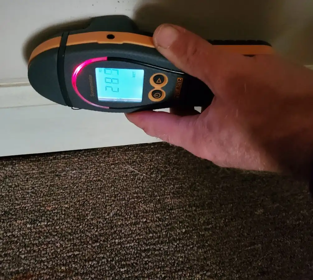 Moisture detection at baseboard during Storm Damage Restoration in Two Rivers